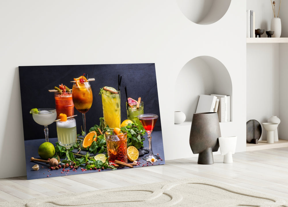 Cocktails close-up showing seven cocktails with herbs and fruit garnish on slate counter