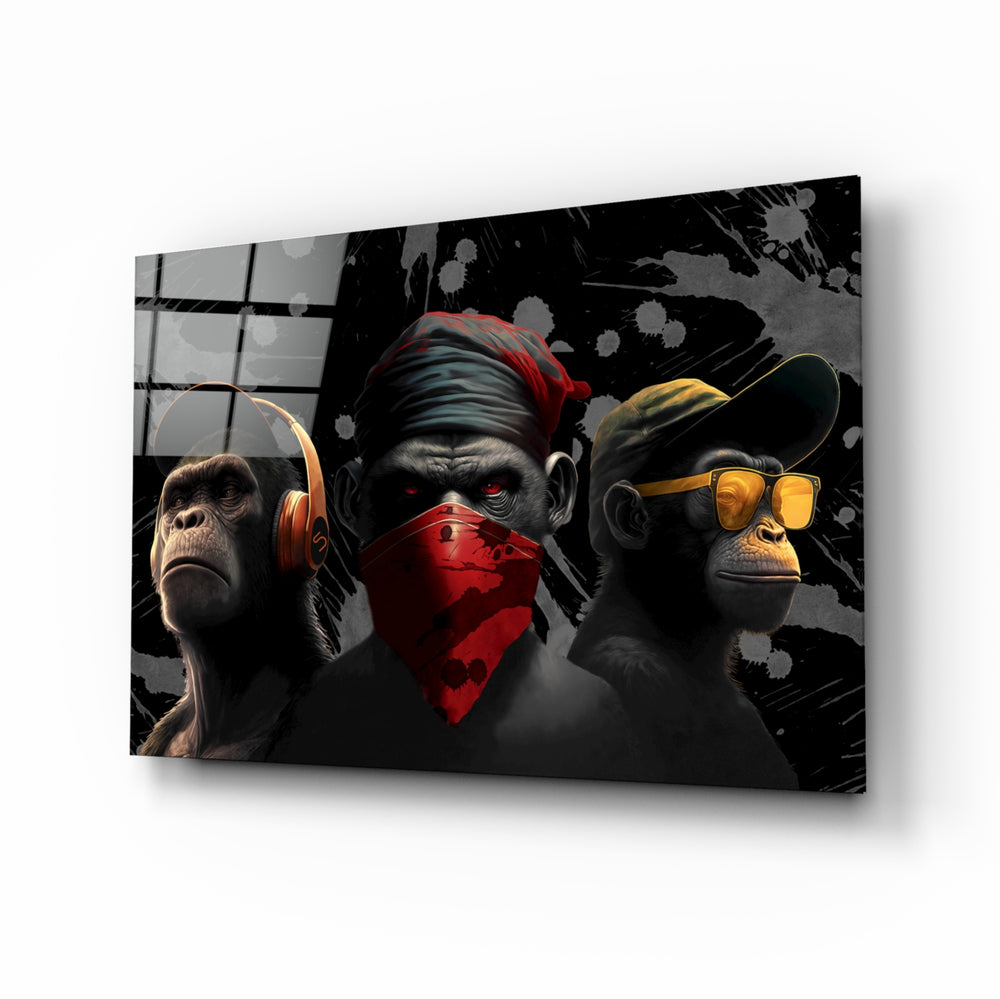 3 Wise Monkeys glass wall art displayed above a black leather sectional in a moody man cave with brass sconces