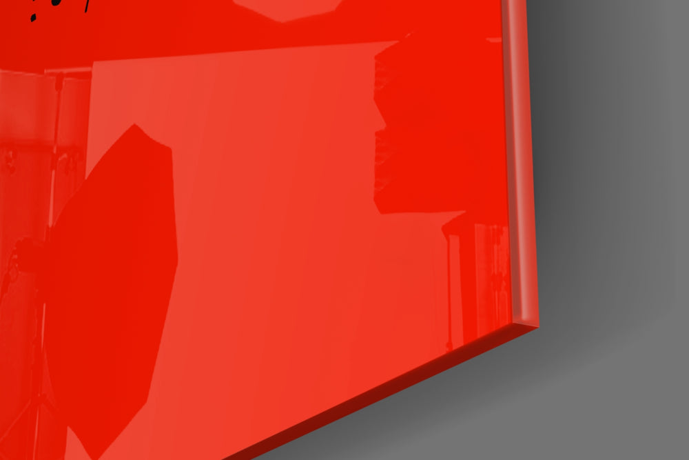 Typographic artwork anchoring a desk wall with black-on-crimson palette
