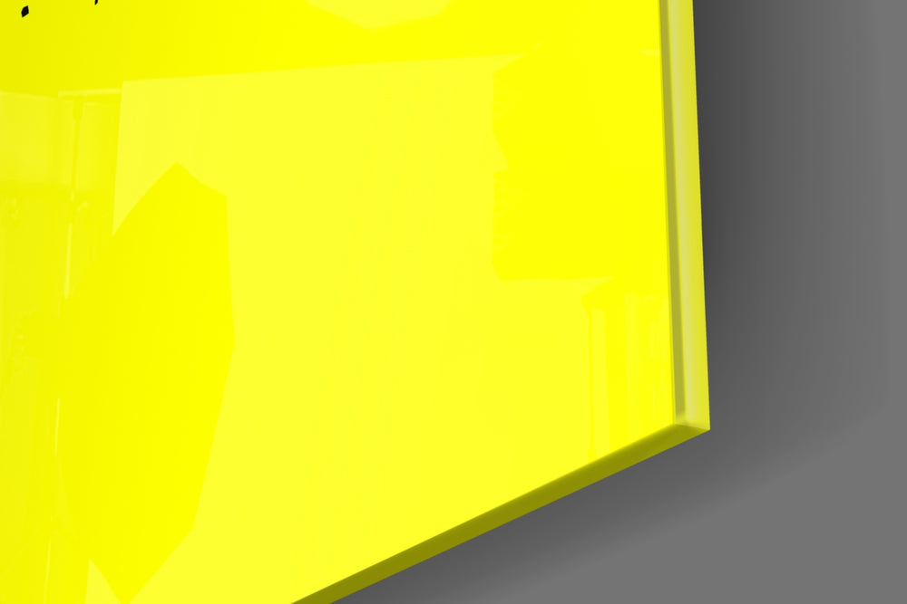 Typographic artwork anchoring a desk wall with black-on-lemon palette