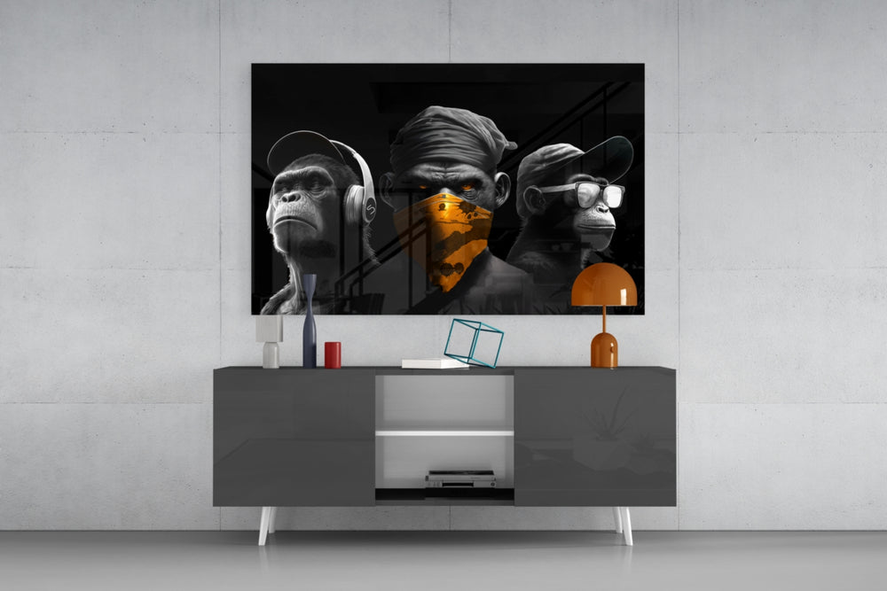 Wise Monkeys panel catching lamp light to reveal its chrome-edition trio