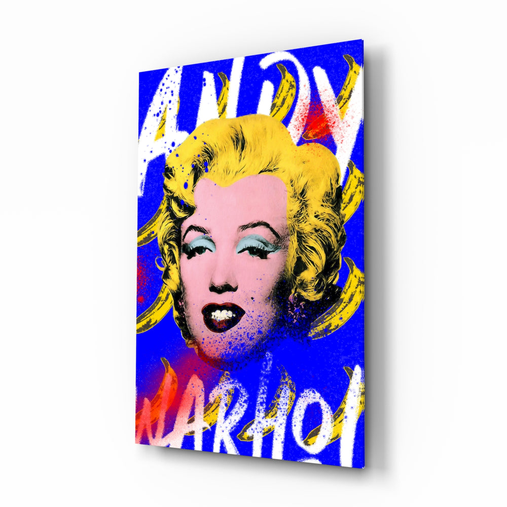 Andy Warhol and Marilyn glass wall art displayed above a workbench in a creative studio
