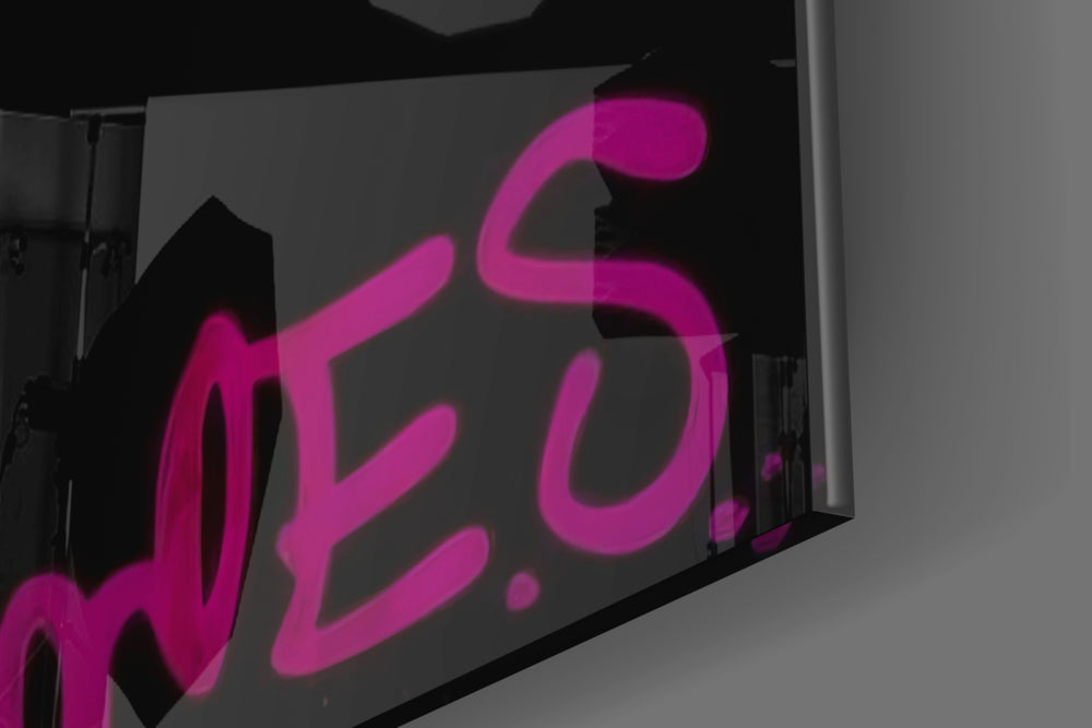 Doughnut-muse artwork anchoring a wall with magenta-and-cyan palette