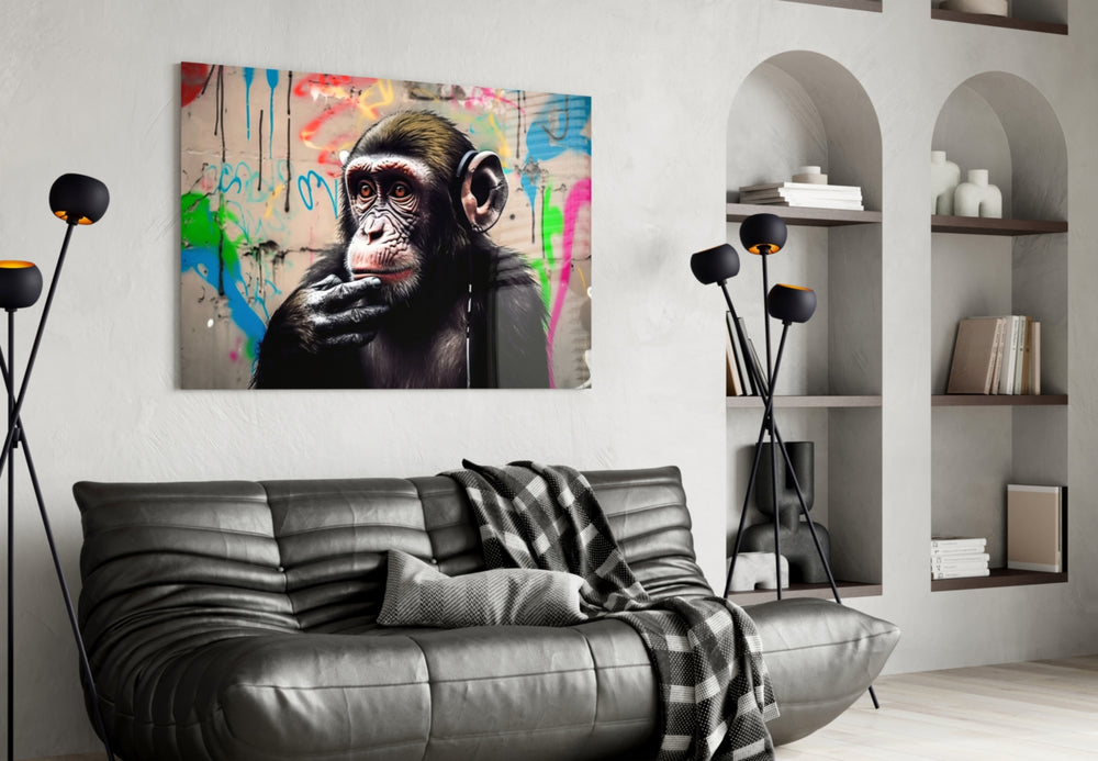 Thinking Monkey glass wall art styled above a desk in a creative office
