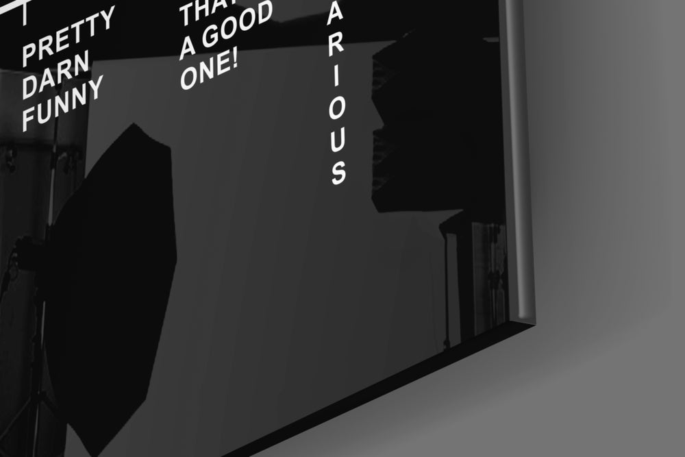 Typography artwork anchoring a wall with obsidian-and-ivory palette