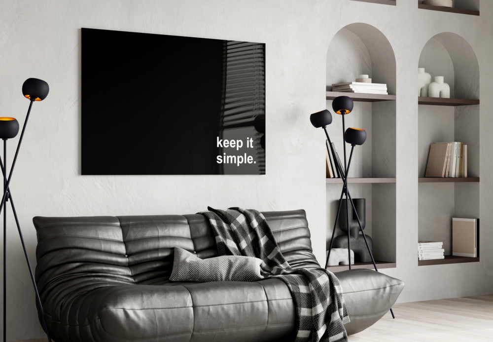 Keep It Simple glass wall art styled above a sideboard in a study