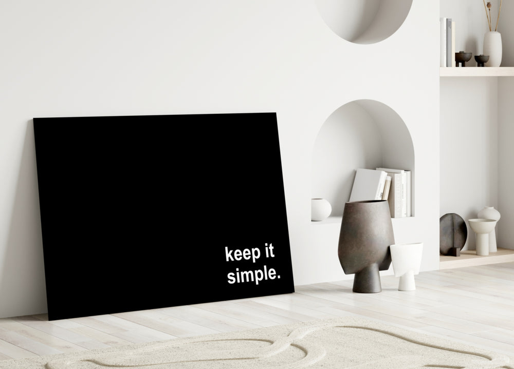 Keep It Simple close-up showing lowercase white sans-serif on black