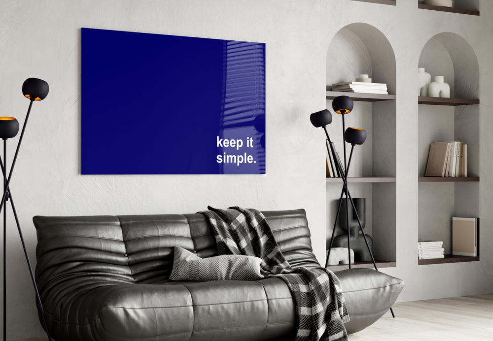 Simple glass wall art styled above a sideboard in a study