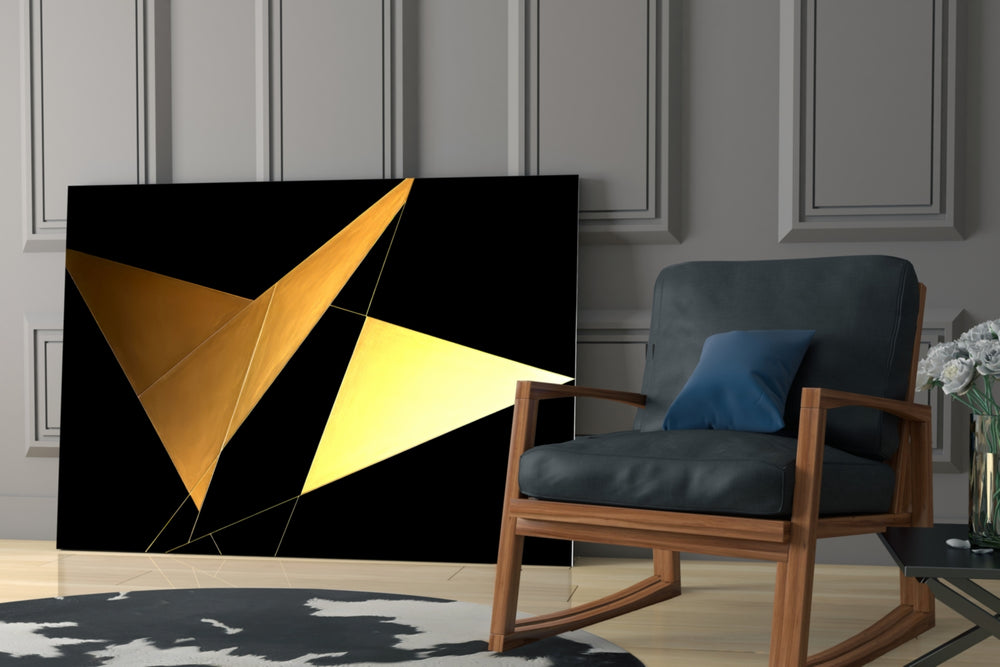 Angular-wing artwork anchoring a wall with gold-and-onyx palette