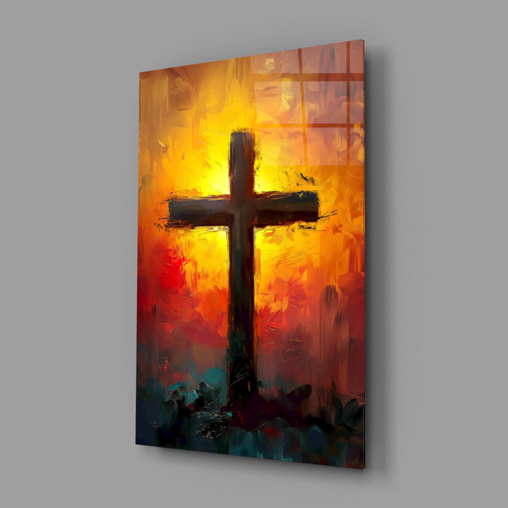 Cross close-up showing silhouette on amber-scarlet sunrise