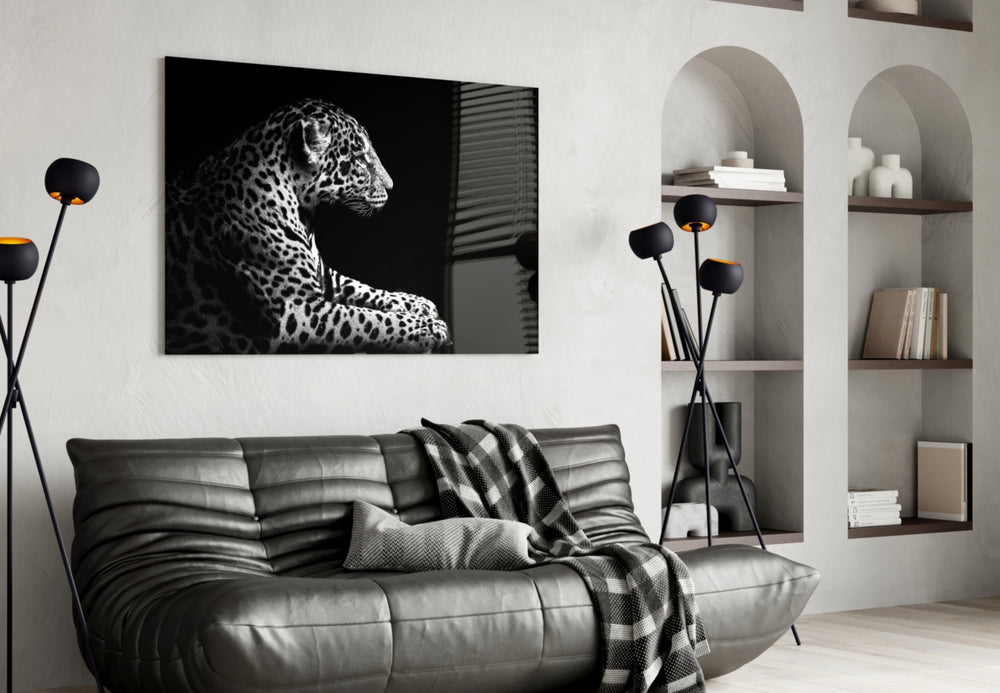 Leopard glass wall art styled above a sofa in a safari-lounge living room