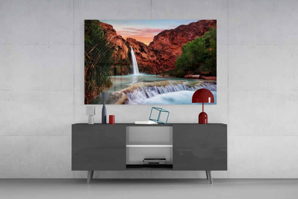 Waterfall panel catching warm light to reveal its turquoise pool