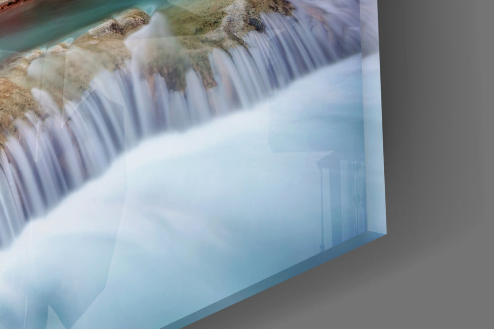 Waterfall artwork anchoring a southwestern-themed wall in warm palette