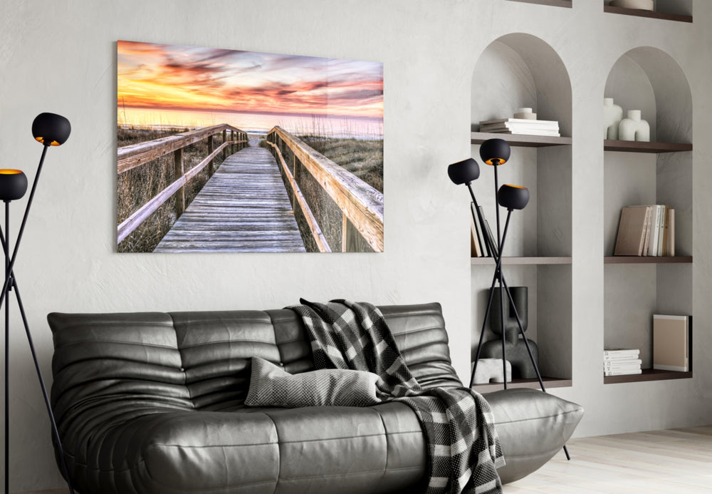 Sunset on the Dock glass wall art styled above a sofa in a seaside-mood living room