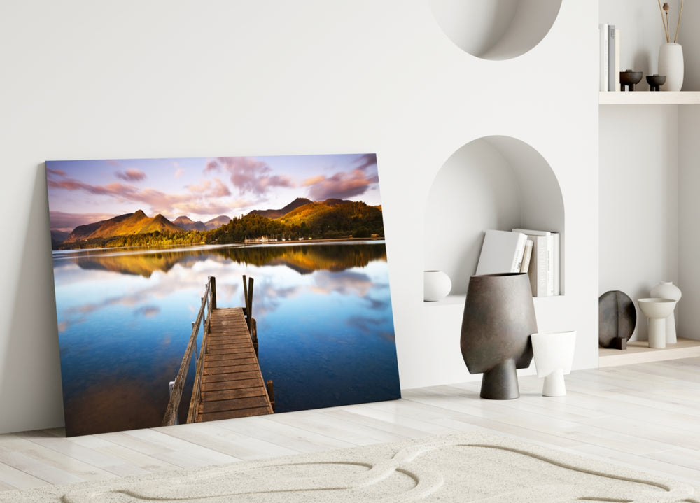 Close-up detail of timber jetty and mountain reflection on still water