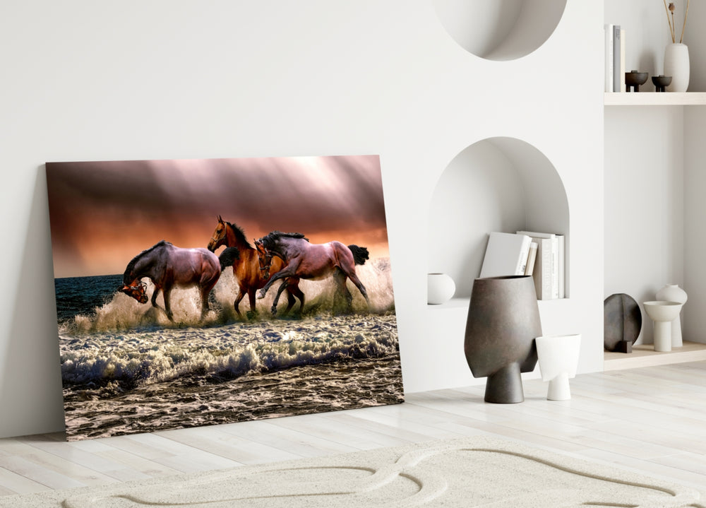 Close-up detail of three horses thundering through ocean surf at sunset
