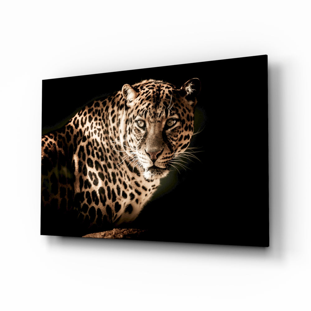 Leopard glass wall art displayed above a console in a designer interior