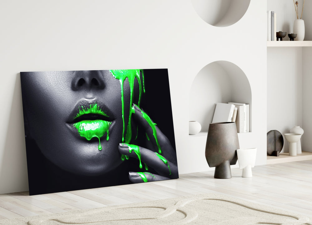 Close-up detail of neon green paint dripping from lips and fingertips