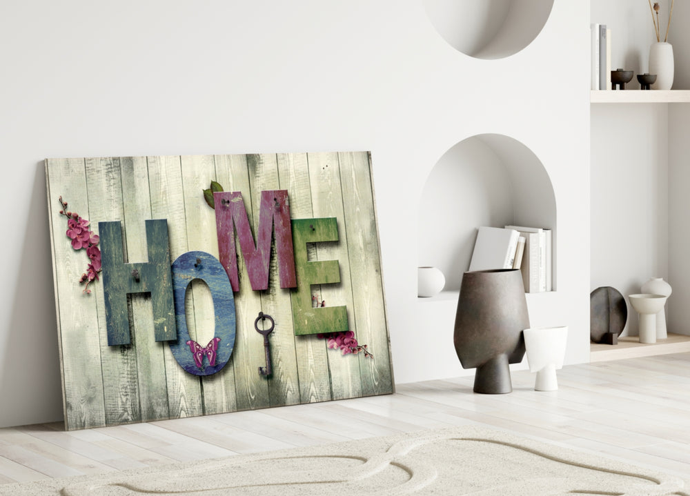 Close-up detail of weathered HOME letters with skeleton key and blossoms