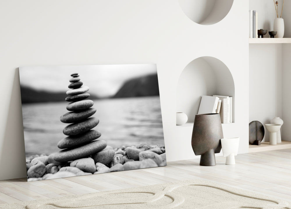Close-up detail of balanced pebble cairn on a smooth lakeshore