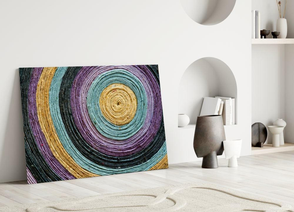 Close-up detail of violet, teal and mustard concentric paper-cord rings