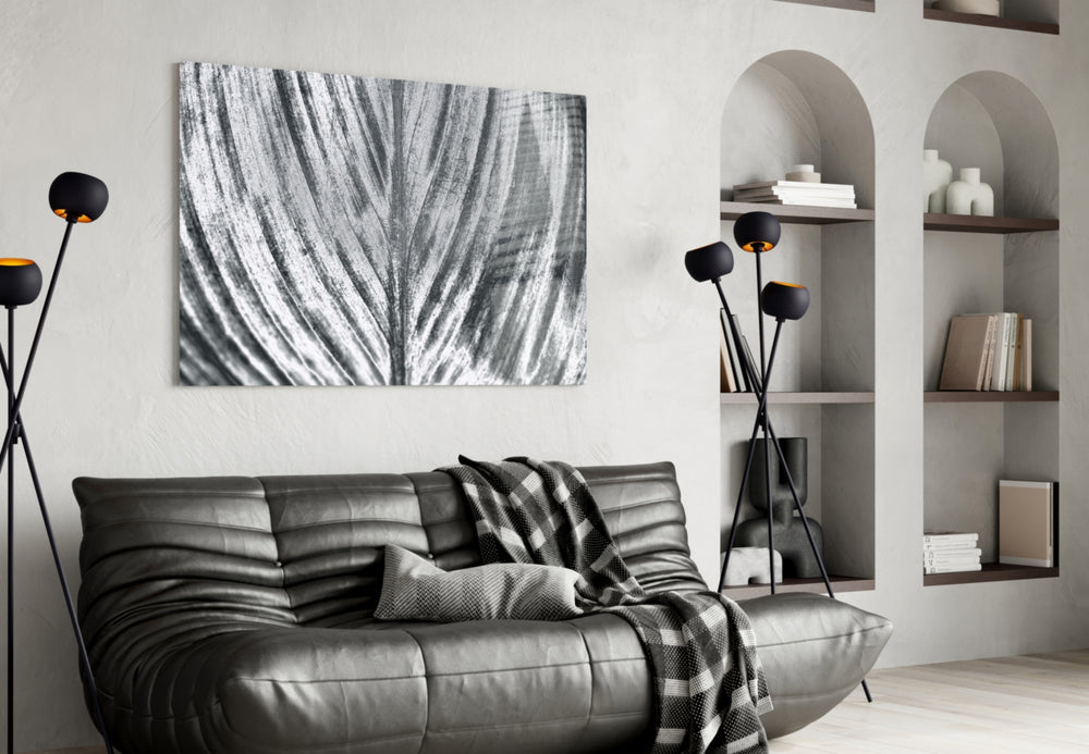 Leaf glass wall art styled above a desk in a botanical study