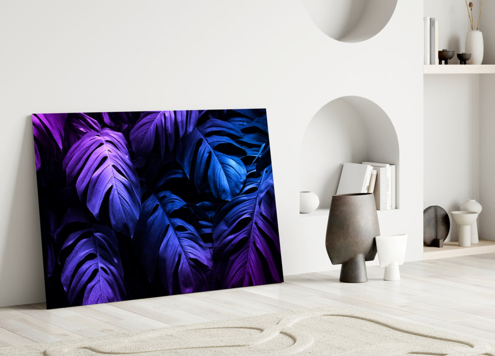 Close-up detail of violet-and-cobalt monstera fronds against deep black