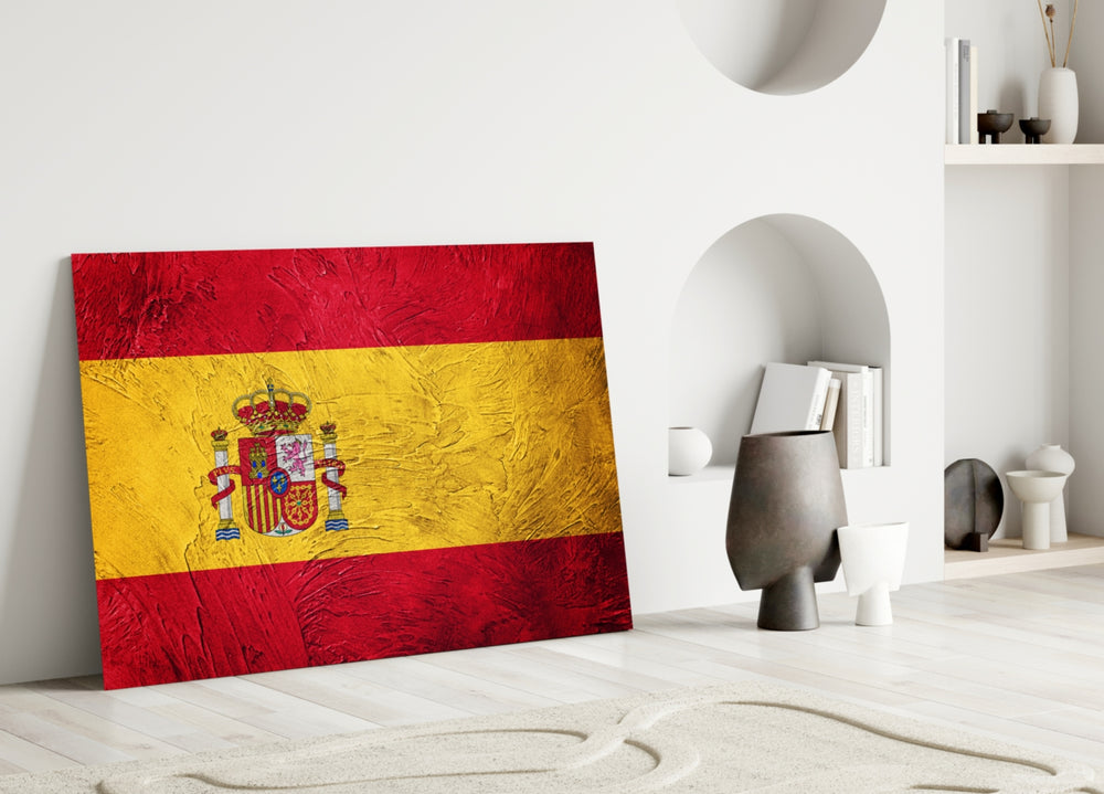 Close-up detail of red-and-yellow stripes meeting Spanish coat-of-arms
