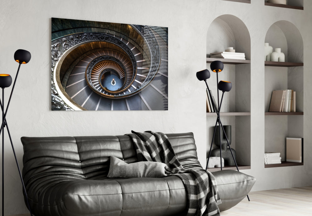 Spiral glass wall art styled above a desk in a travel-memory study