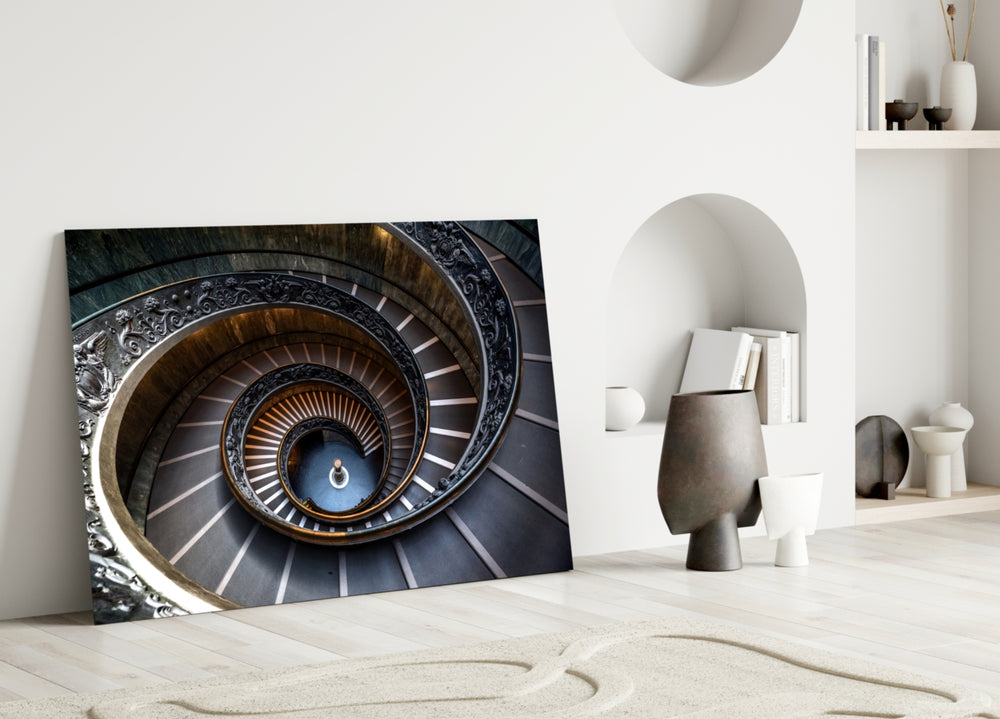 Close-up detail of carved scrollwork railing on a marble spiral staircase