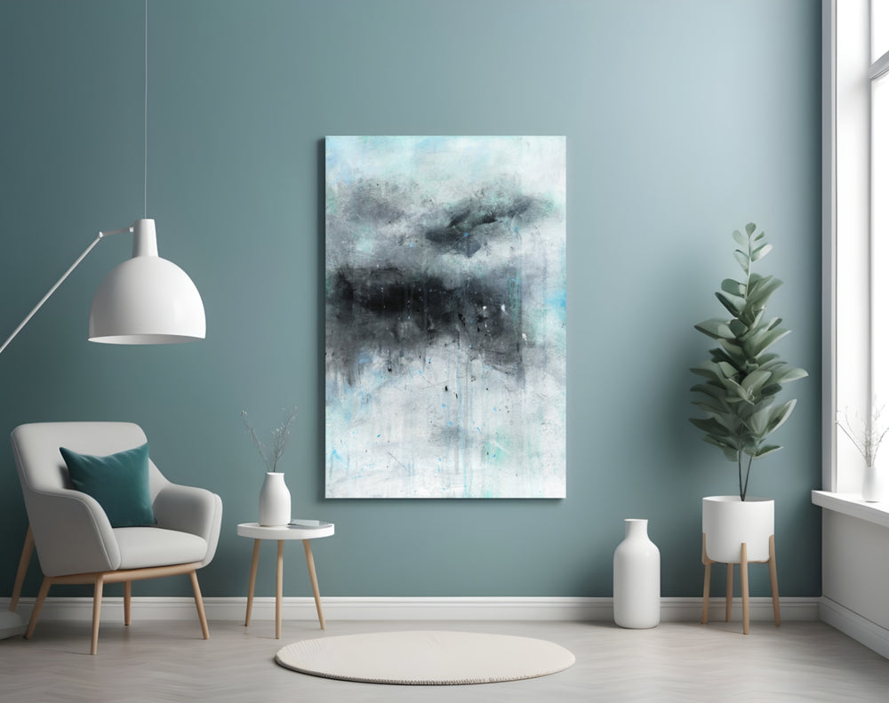 Abstract glass wall art styled above a sofa in a brooding-palette lounge