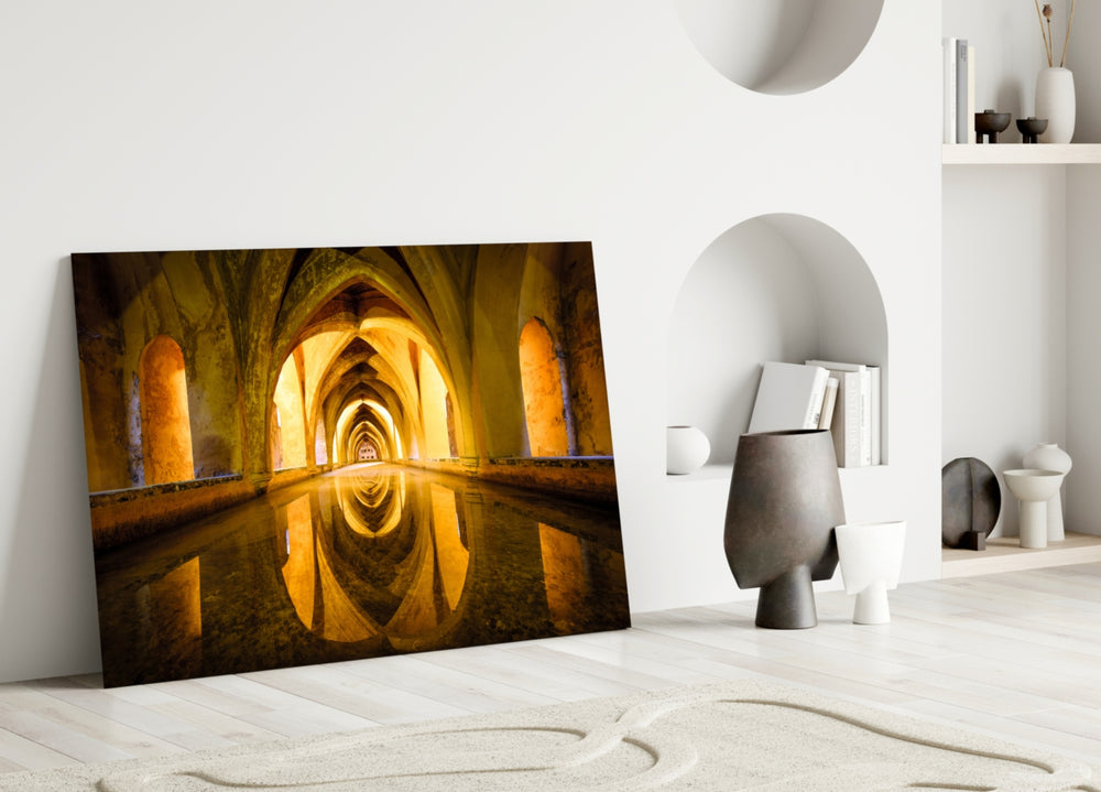 Close-up detail of honey-toned Moorish arches mirrored in still water