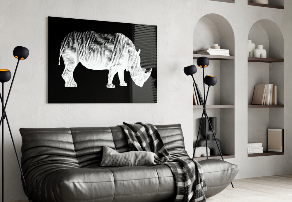 Rhino glass wall art styled above a desk in an editorial study