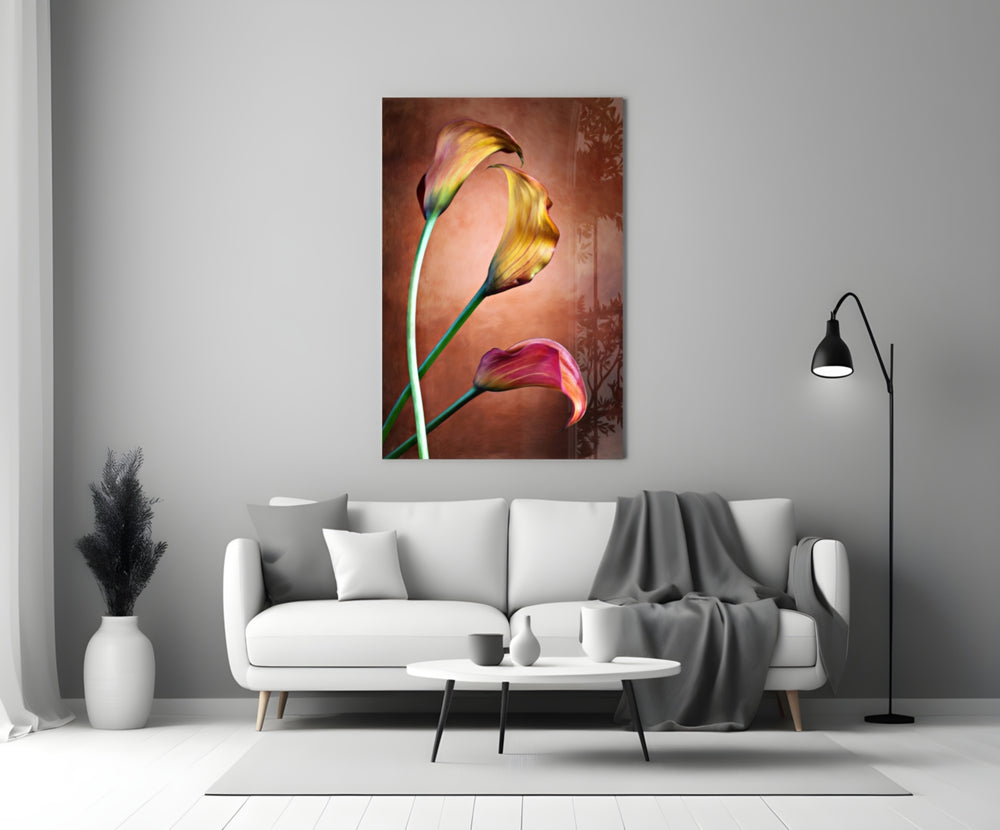 Close-up detail of golden-yellow and ruby calla blooms on copper bronze