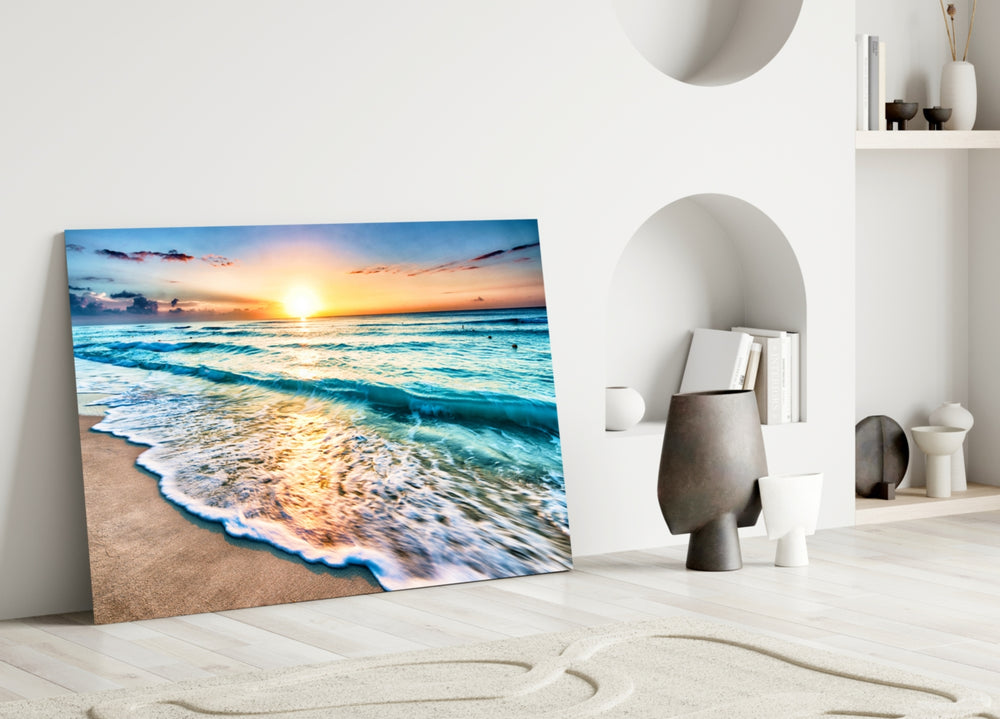 Close-up detail of turquoise tide rolling onto beige sand at sunset