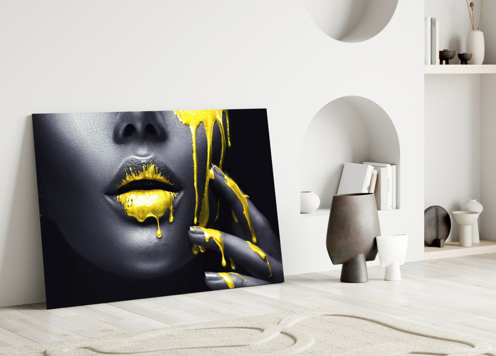 Close-up detail of molten yellow streaming from charcoal lips