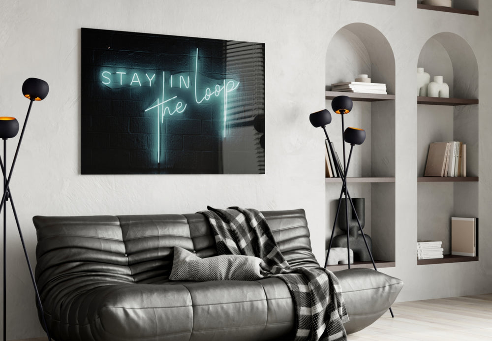 Stay in the Loop glass wall art styled above a desk in a creative office