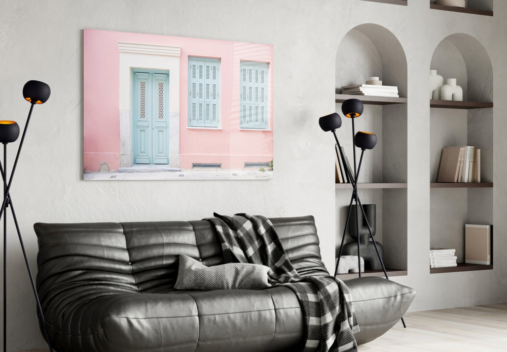Pink House glass wall art styled above a bench in a hallway