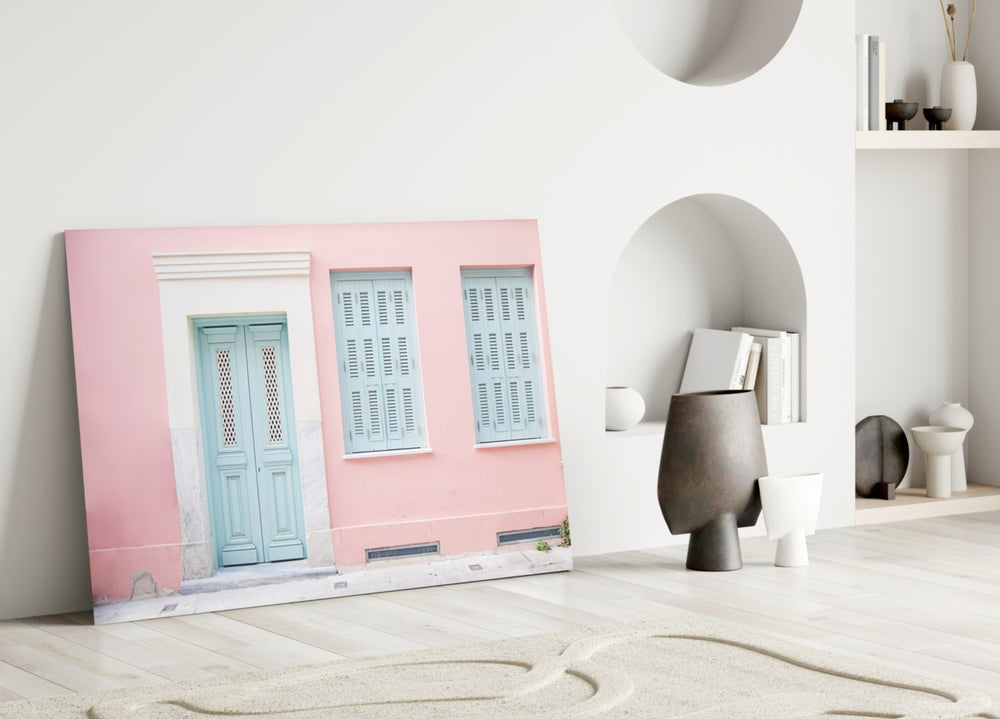 Close-up detail of mint shutters against blush stucco