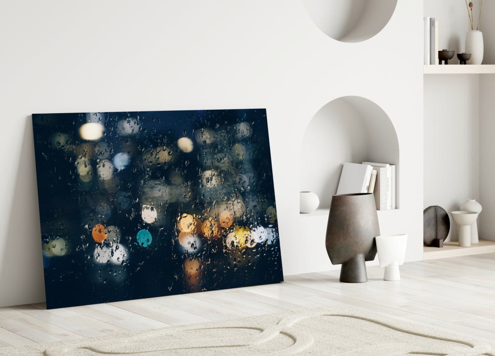 Close-up detail of raindrops on glass with city-light bokeh