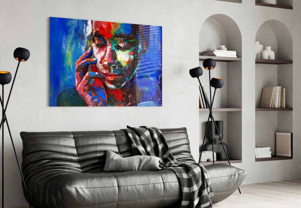 Women's glass wall art styled above a desk in an art studio