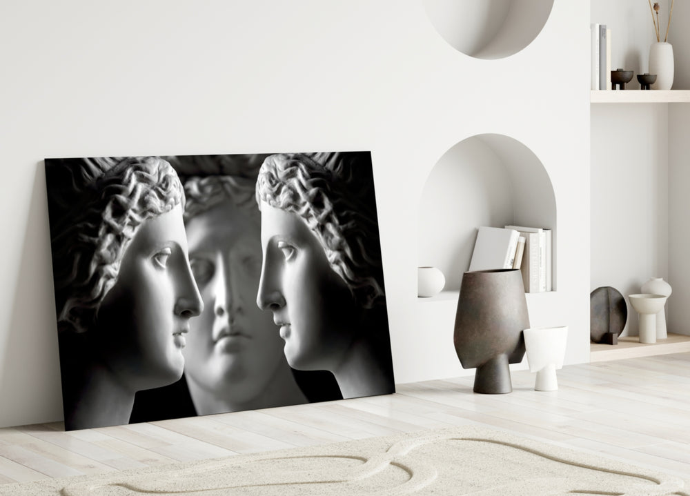 Close-up detail of marble profiles facing the central frontal bust