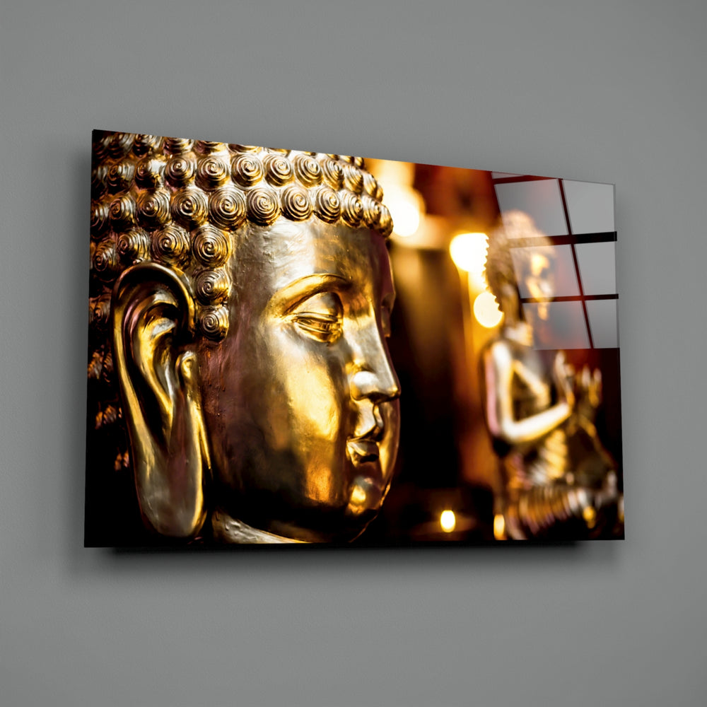Close-up detail of golden Buddha bust behind glass