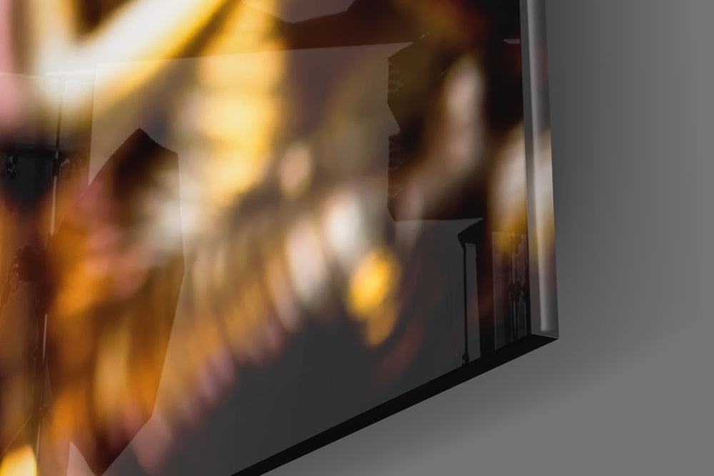 Golden Buddha glass wall art catching light to reveal its painted gold