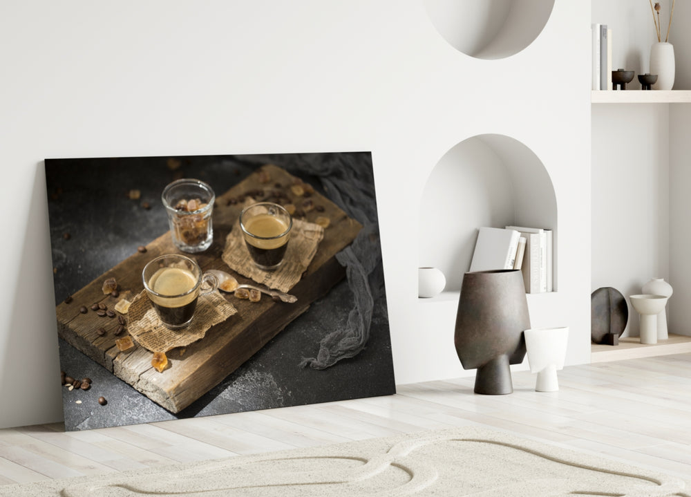 Close-up detail of espresso glasses on rustic wood behind glass