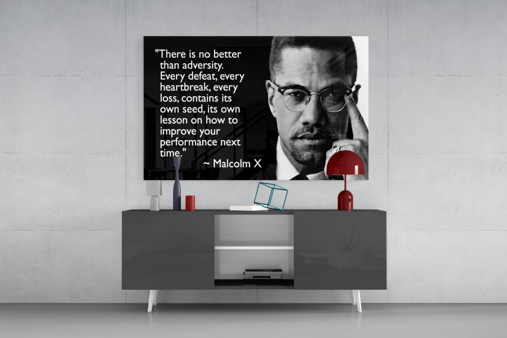 Words of Malcolm X glass wall art catching light to reveal its painted detail