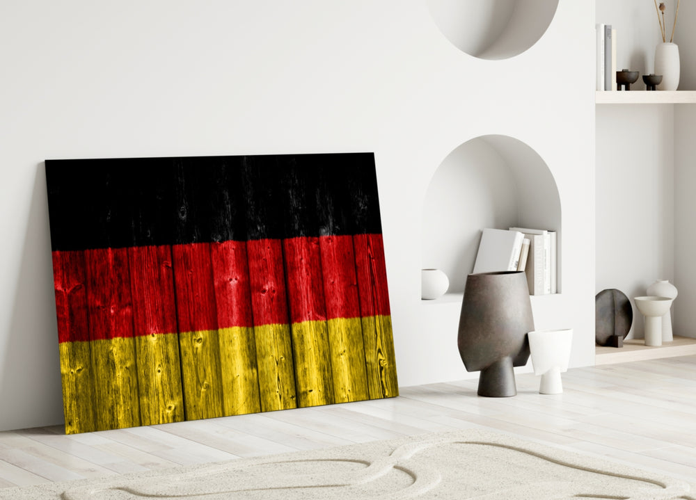 Close-up detail of weathered-wood German flag behind glass