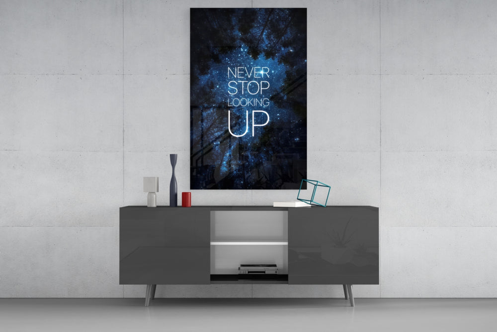 Never Stop glass wall art catching light to reveal its painted stars