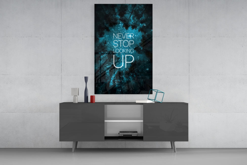 Never Stop glass wall art catching light to reveal its painted stars
