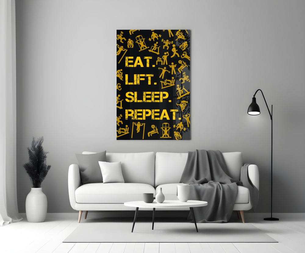 Close-up detail of saffron Eat Lift Sleep Repeat typography behind glass